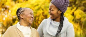 Two women smiling at each other.