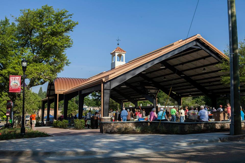 People sitting under a shed.