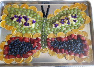 A platter of fruit arranged to look like a butterfly.