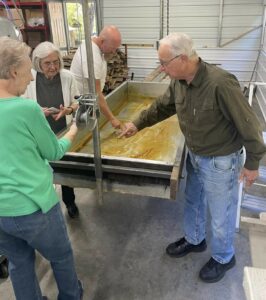 A group tours a processing room.